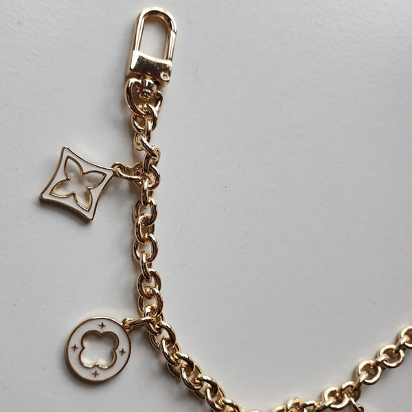 Gold Bag Charm with White Charms Accessories Source Unknown 